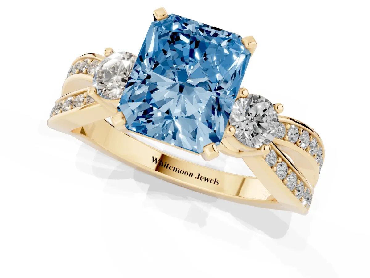 Fancy Blue Three-Stone Radiant Cut Cut Diamond Twist Band with Prong Setting Yellow gold
