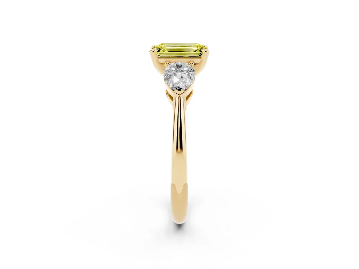 Fancy Yellow Three-Stone Emerald Cut Diamond Ring with Pear Side Stones and Four-Prong Setting Yellow gold