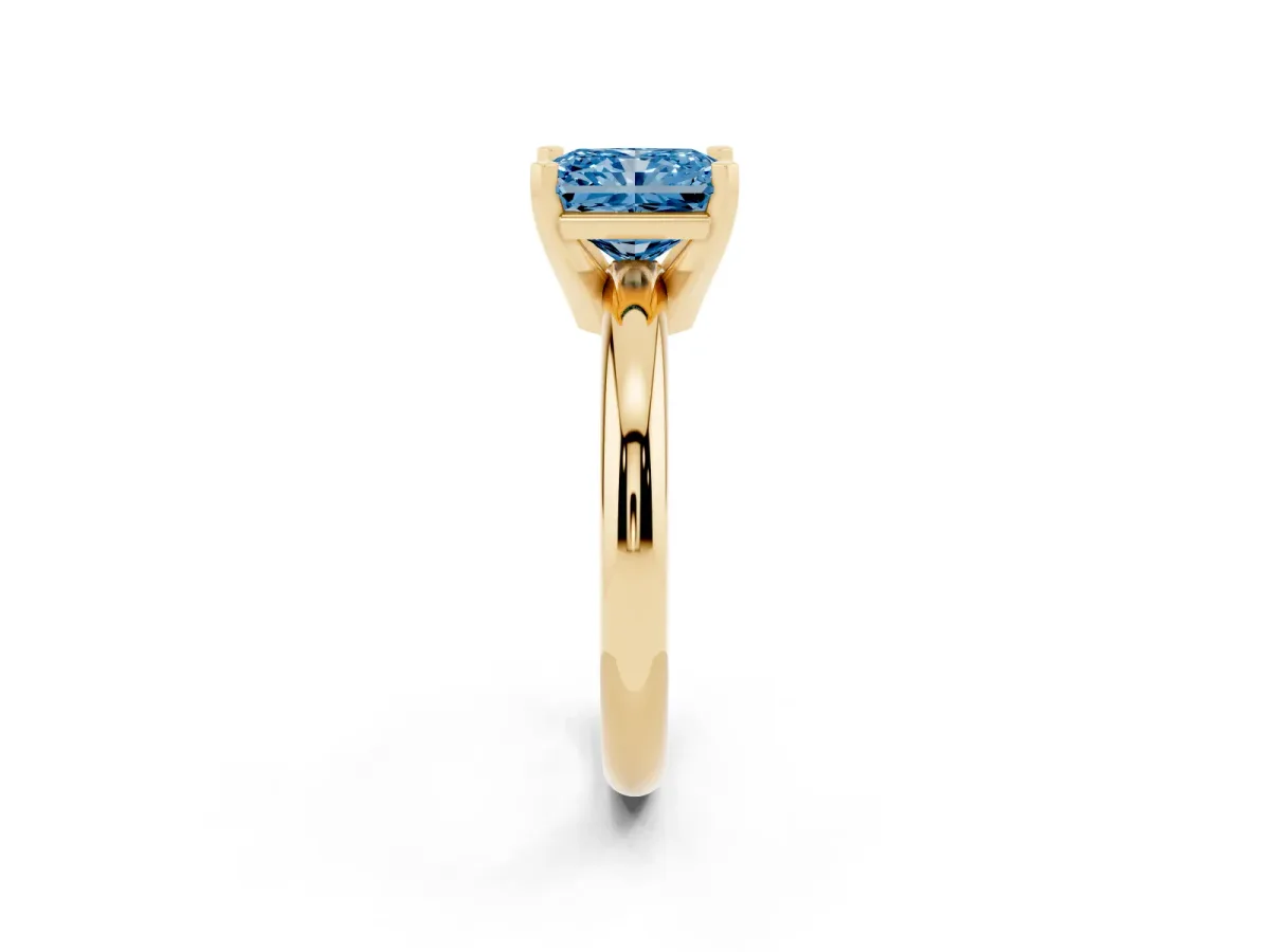 Fancy Blue Radiant Cut Diamond Solitaire Engagement Ring with Round Band and Four-Prong Setting Yellow gold
