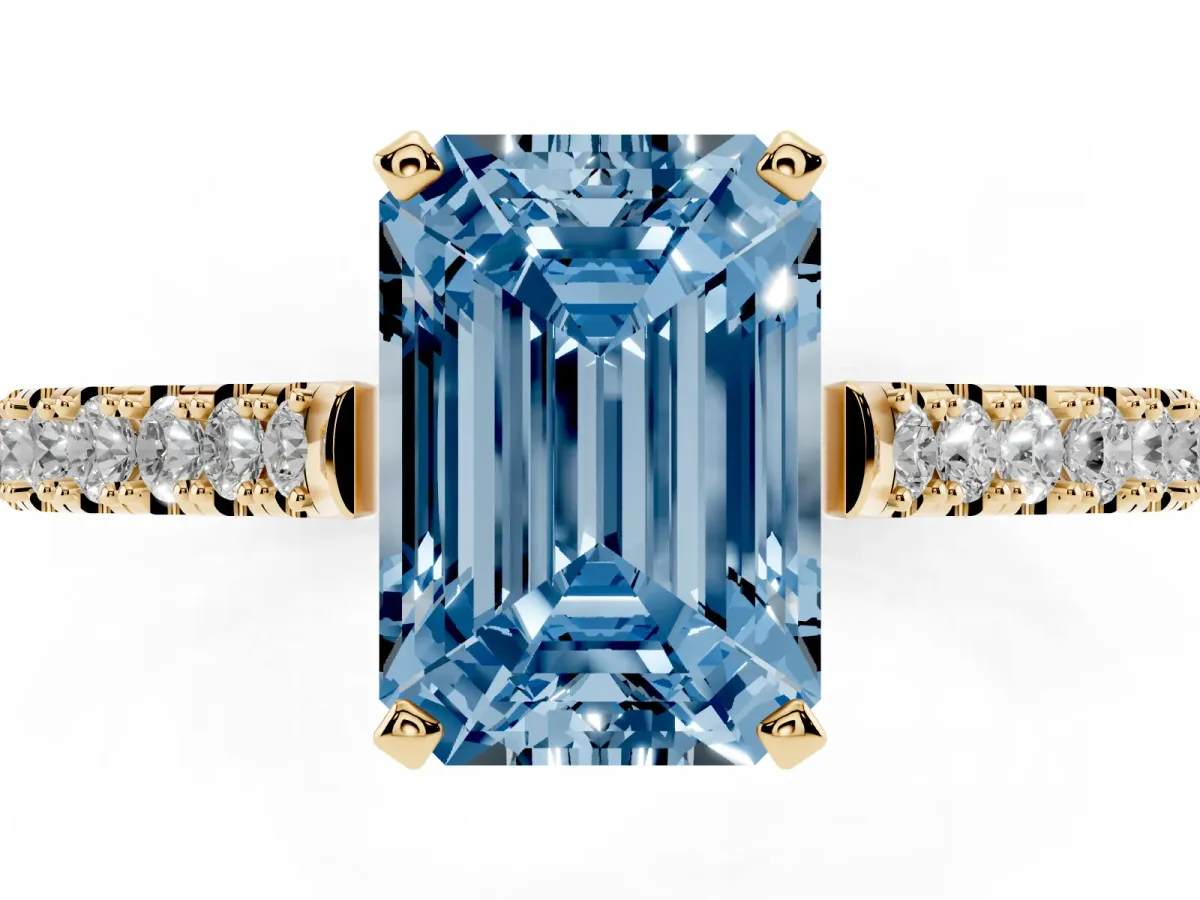 Fancy Blue Emerald Cut Cut Solitaire Diamond Engagement Ring with Pave Band and Four-Prong Setting Yellow gold