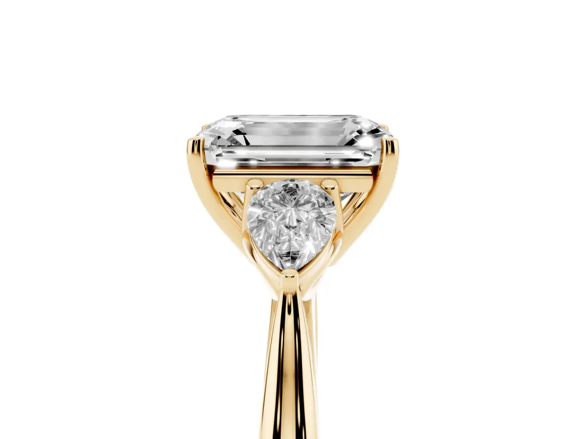Emerald Cut Diamond Three-Stone Ring with Pear Side Stones and Prong Setting Yellow gold