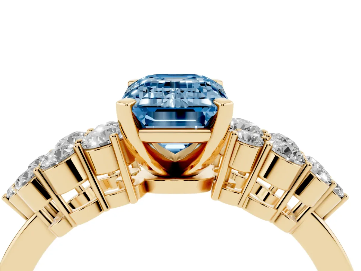Fancy Blue Emerald Cut Cluster Diamond Engagement Ring with Pavé Band and Four-Prong Setting Yellow gold