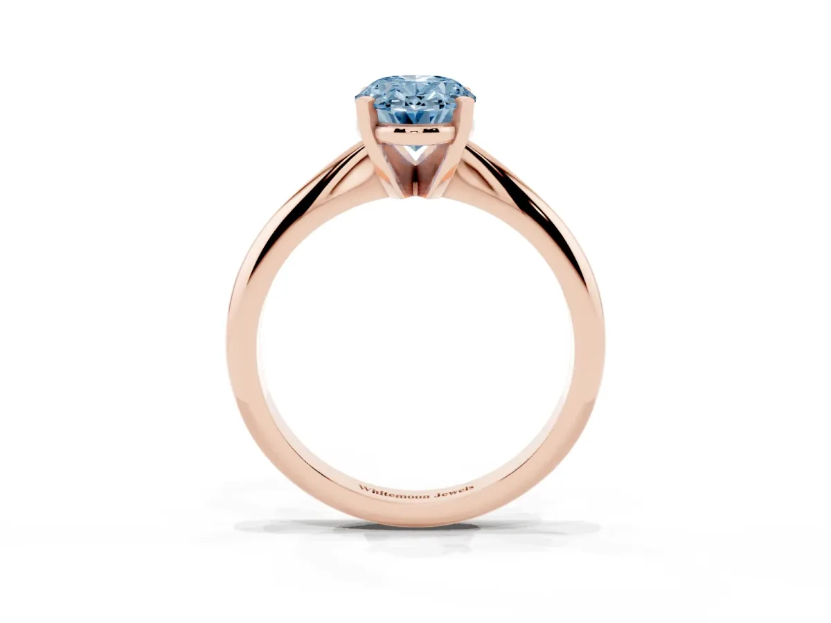 Fancy Blue Oval Cut Cut Solitaire Ring with Four-Prong Setting on a Classic Band Rose gold
