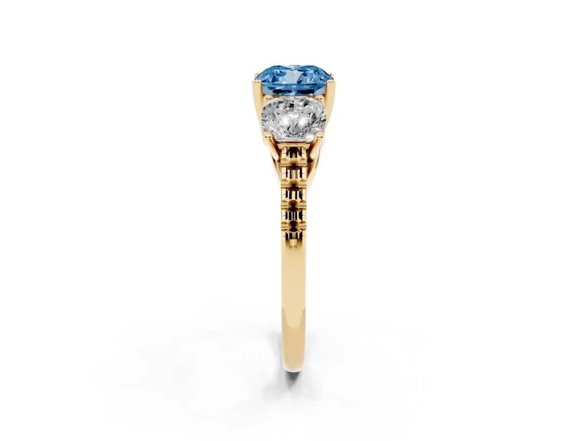 Fancy Blue Three-Stone Cushion Cut Diamond Ring with Round Pavé Band and Prong Setting Yellow gold