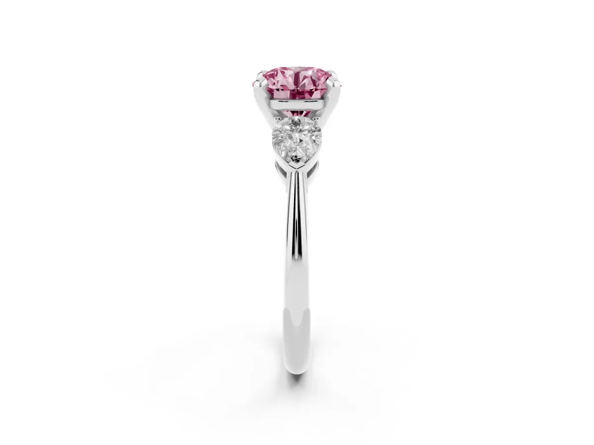 Fancy Pink Three-Stone Round Cut Diamond Ring with Pear Side Stones and Four-Prong Setting Platinum