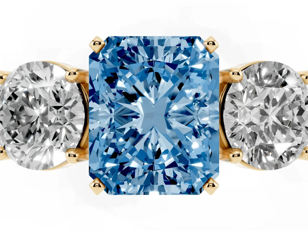 Fancy Blue Three-Stone Radiant Cut Diamond Ring with Round Side Stones, Classic Band, and Four-Prong Setting Yellow gold