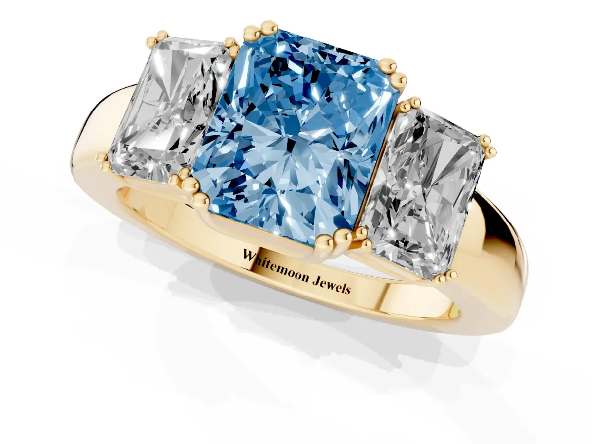 Fancy Blue Three-Stone Radiant Cut Cut Diamond Ring with Channel Set Band and Four-Prong Setting Yellow gold