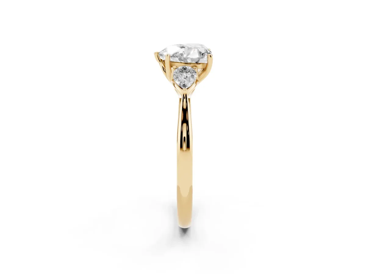 Three-Stone Heart Cut Brilliant Diamond Solitaire Ring with Tapered Band and Four-Prong Setting Yellow gold