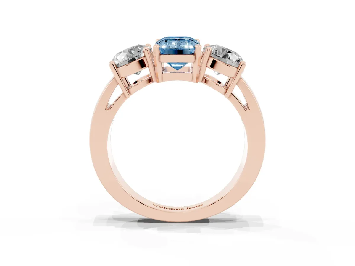Fancy Blue Three-Stone Emerald Cut Diamond Ring with Round Side Stones, Classic Band, and Four-Prong Setting Rose gold