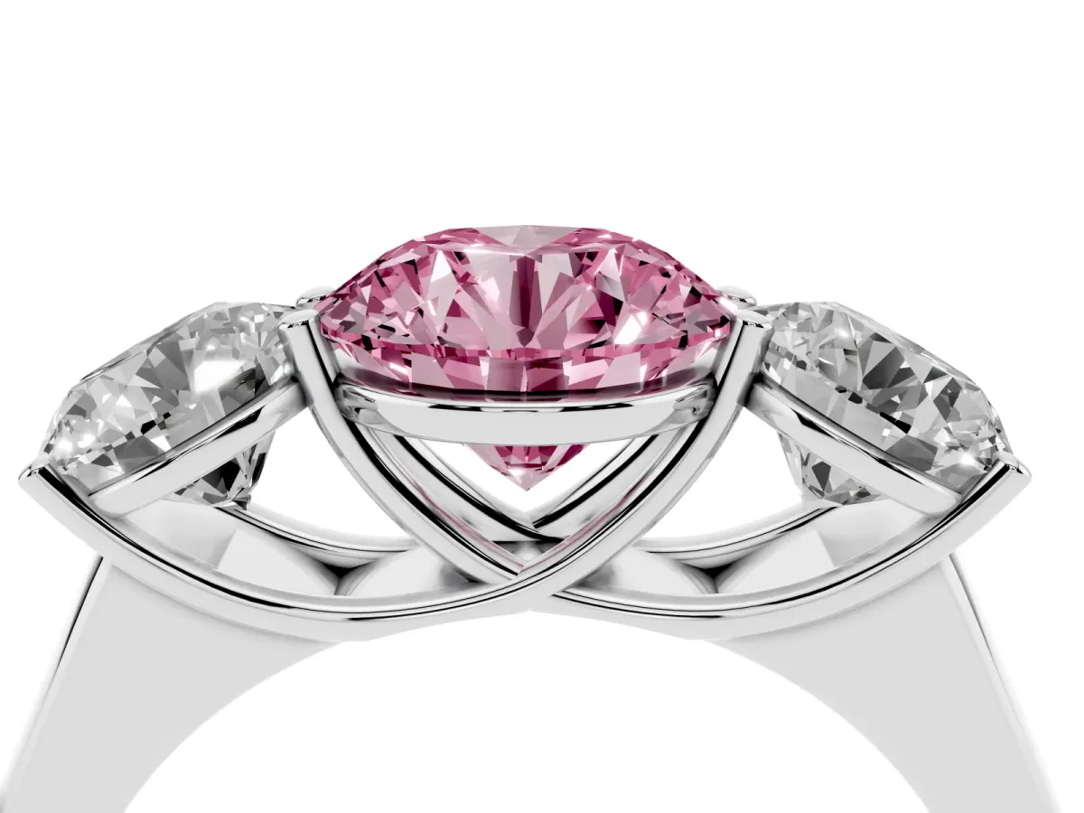 Fancy Pink Round Cut Three-Stone Diamond Ring with Prong Setting on a Classic Band Platinum