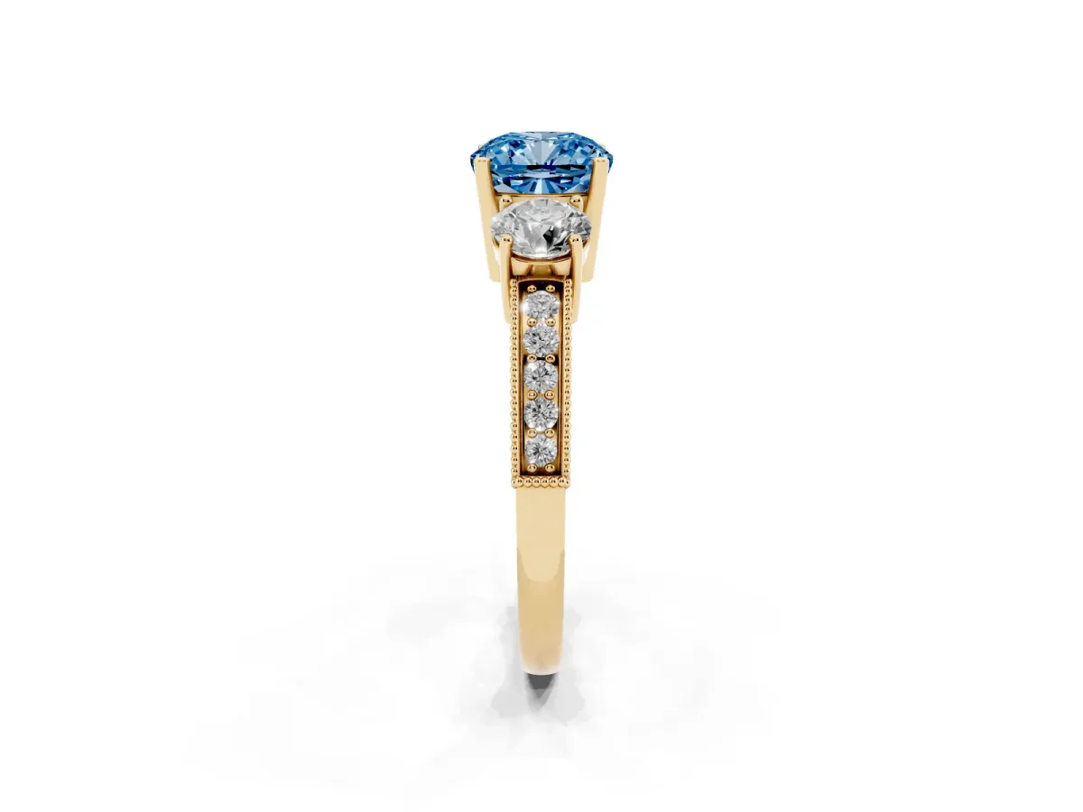 Fancy Blue Cushion Cut Three-Stone Diamond Ring with Pavé Band and Four-Prong Setting Yellow gold