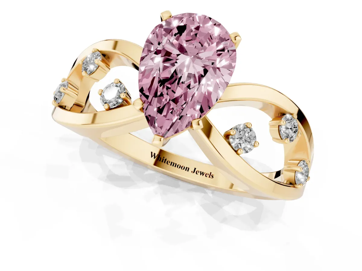 Fancy Pink Pear Cut Cut Solitaire Diamond with Side Stones on Criss-Cross Band and Four-Prong Setting Yellow gold