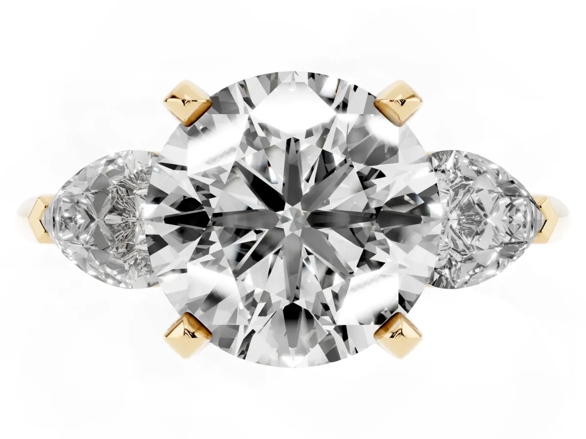 Three-Stone Round Cut Diamond Ring with Pear Side Stones and Four-Prong Setting Yellow gold