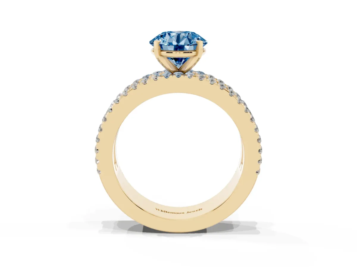Fancy Blue Round Cut Diamond Solitaire Ring with Pavé and Channel Set Band Yellow gold