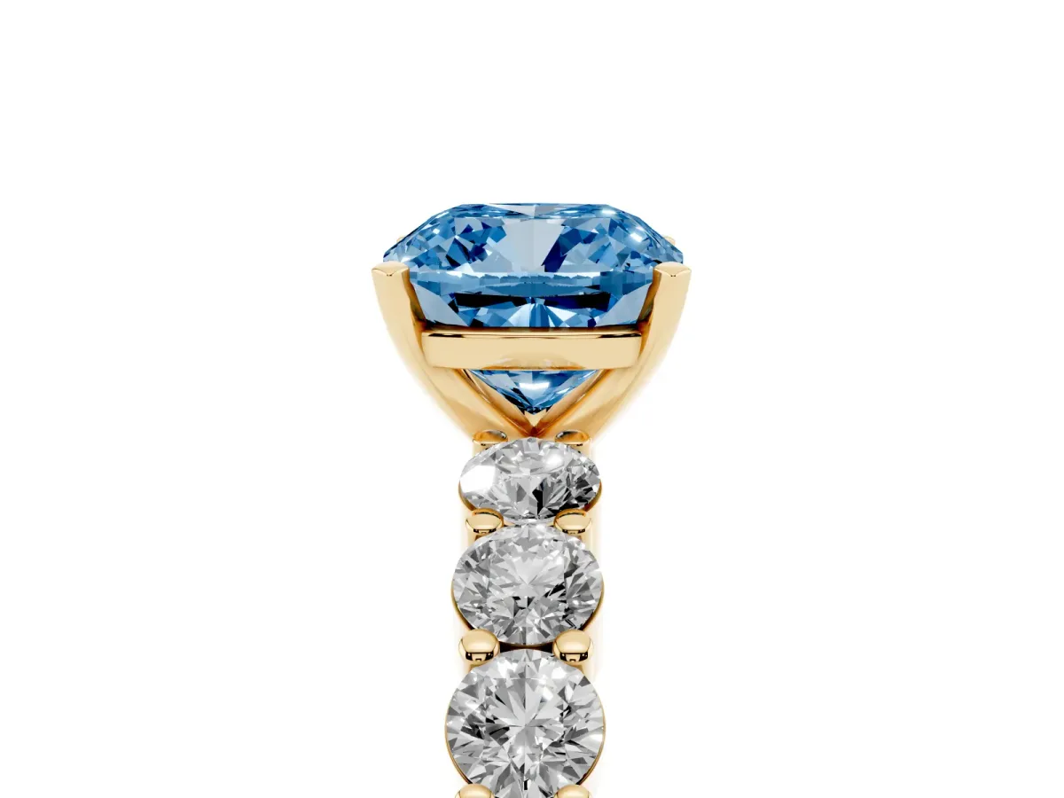 Fancy Blue Cushion Cut Diamond Solitaire Ring with Shared Prong Round Side Stones Yellow gold