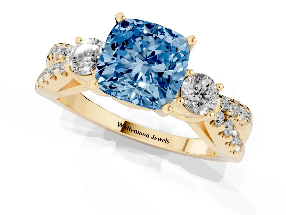 Fancy Blue Cushion Cut Diamond Three-Stone Ring with Pavé Split Shank and Four-Prong Setting Yellow gold
