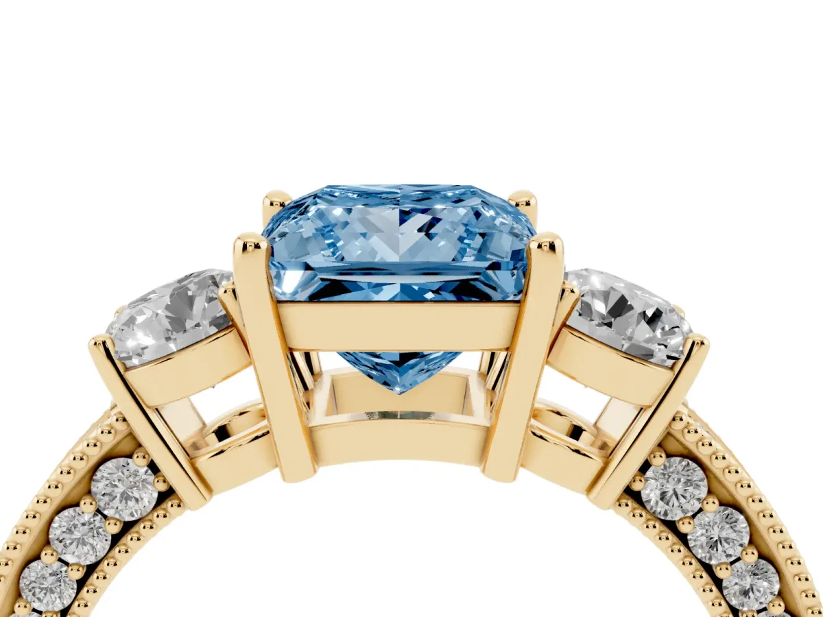 Fancy Blue Princess Cut Three-Stone Diamond Ring with Pavé Band and Four-Prong Setting Yellow gold