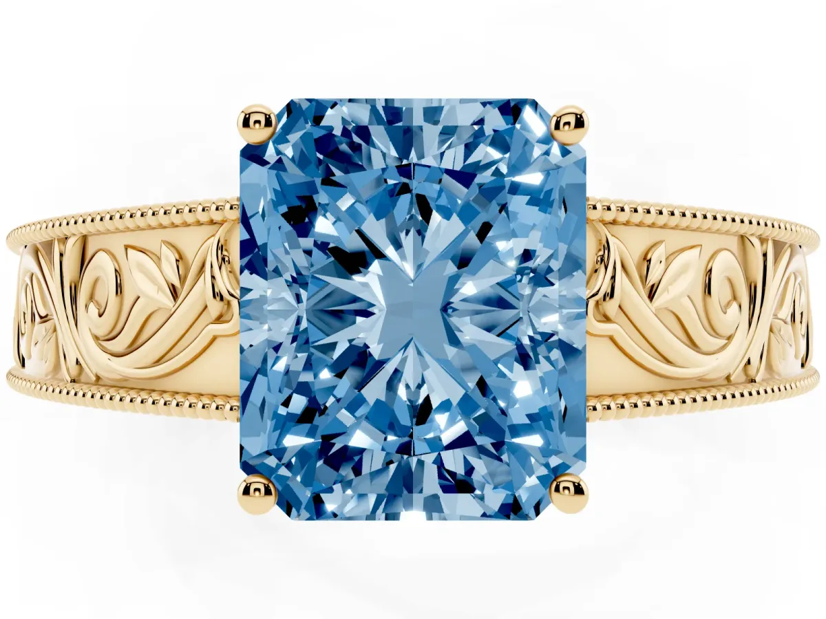 Fancy Blue Radiant Cut Diamond Solitaire Ring with Engraved Band and Four-Prong Setting Yellow gold