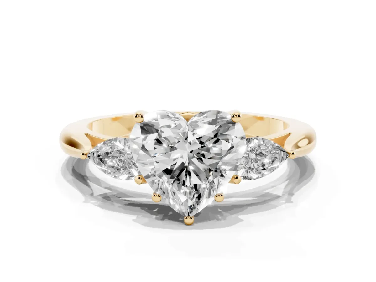 Three-Stone Heart Cut Diamond Ring with Pear Side Stones in Four-Prong Setting Yellow gold