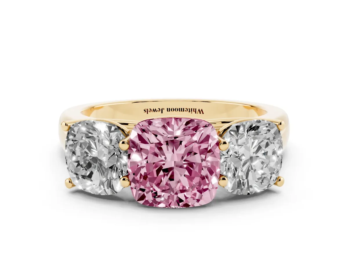 Fancy Pink Cushion Cut Three-Stone Diamond Ring with Prong Setting on a Classic Band Yellow gold