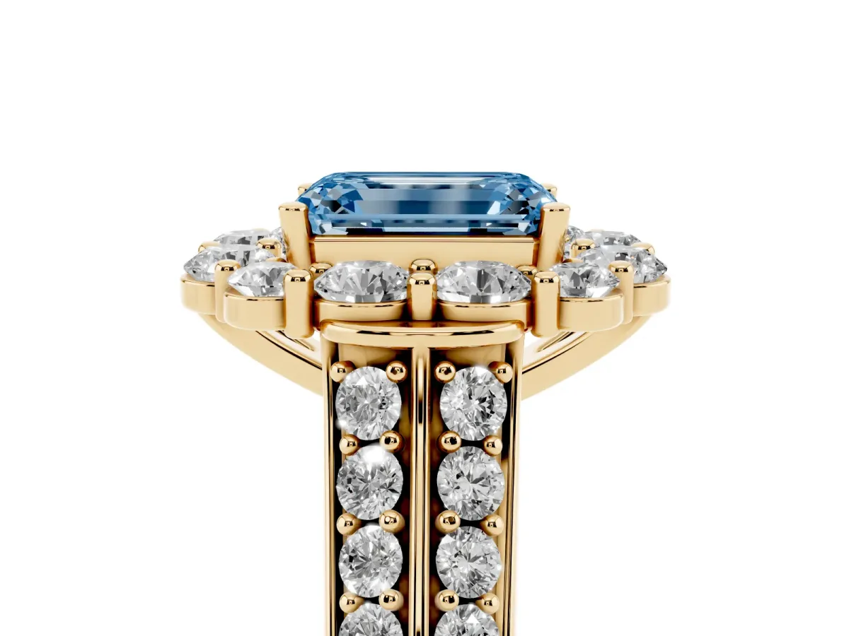 Fancy Blue Emerald Cut Halo Diamond Engagement Ring with Split Shank and Prong Setting Yellow gold