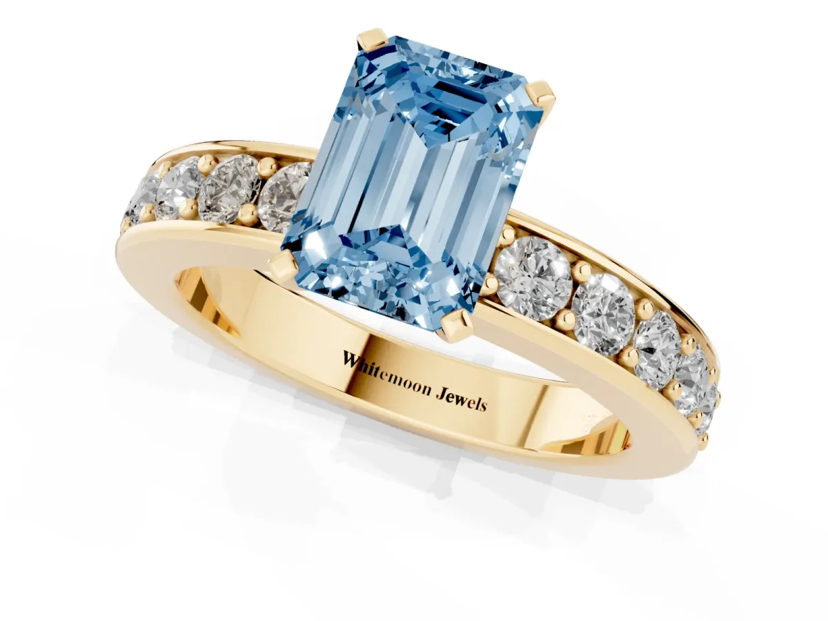 Fancy Blue Emerald Cut Diamond Engagement Ring with Channel Set Round Band and Prong Setting Yellow gold