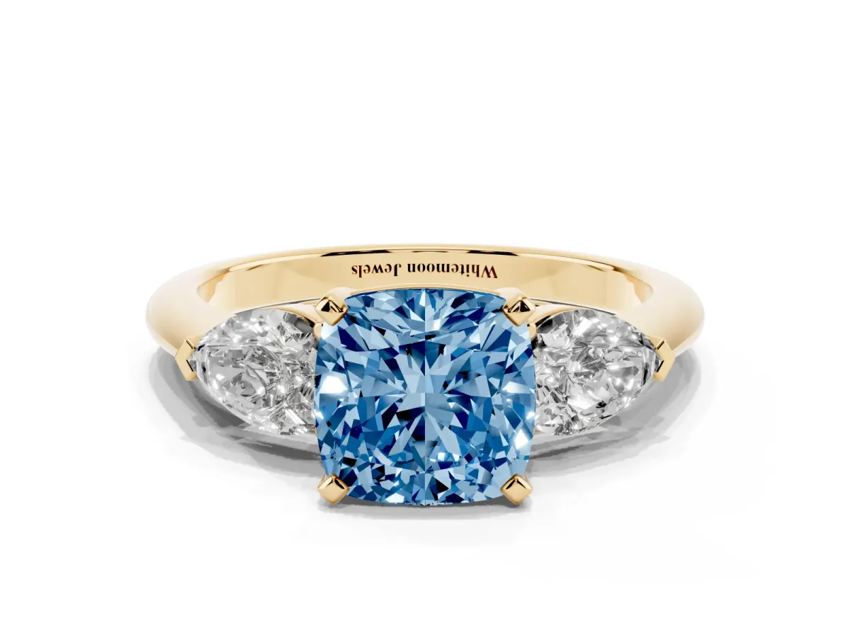 Fancy Blue Three-Stone Cushion Cut Diamond Ring with Pear Side Stones and Four-Prong Setting Yellow gold