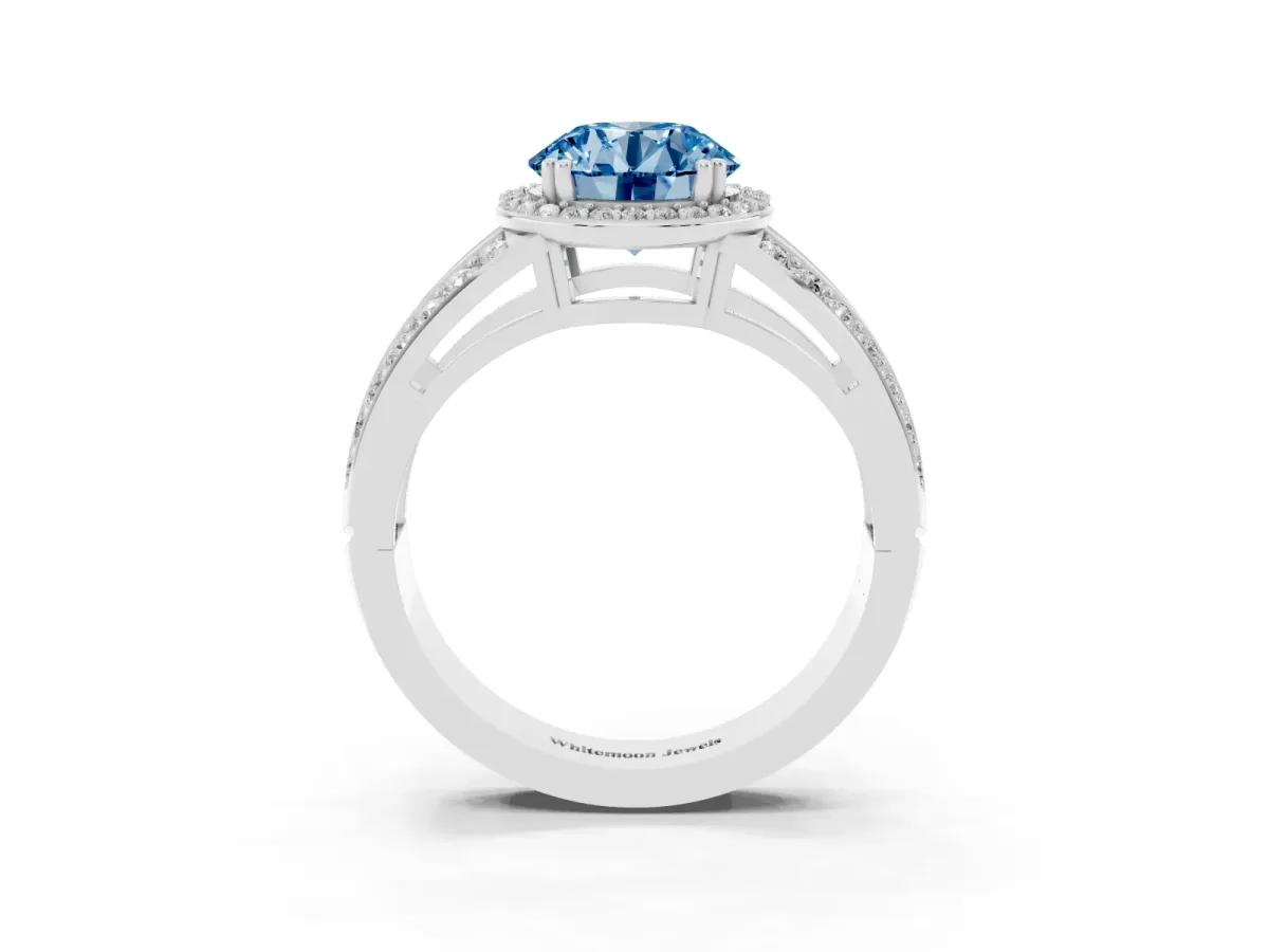 Fancy Blue Round Cut Diamond Halo Ring with Split Shank Pavé Band and Four-Prong Setting Silver