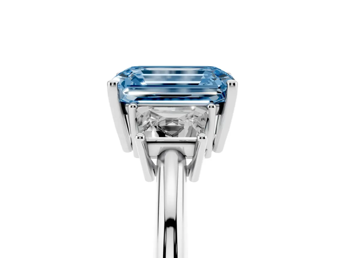 Fancy Blue Emerald Cut Diamond Three-Stone Ring with Trapezoid Side Stones and Prong Setting Platinum