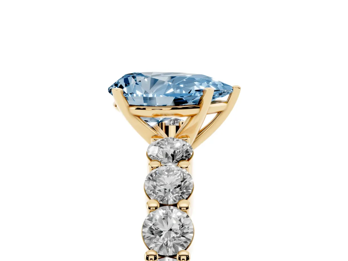 Fancy Blue Pear Cut Diamond Solitaire Ring with Shared Prong Round Side Stones Yellow gold