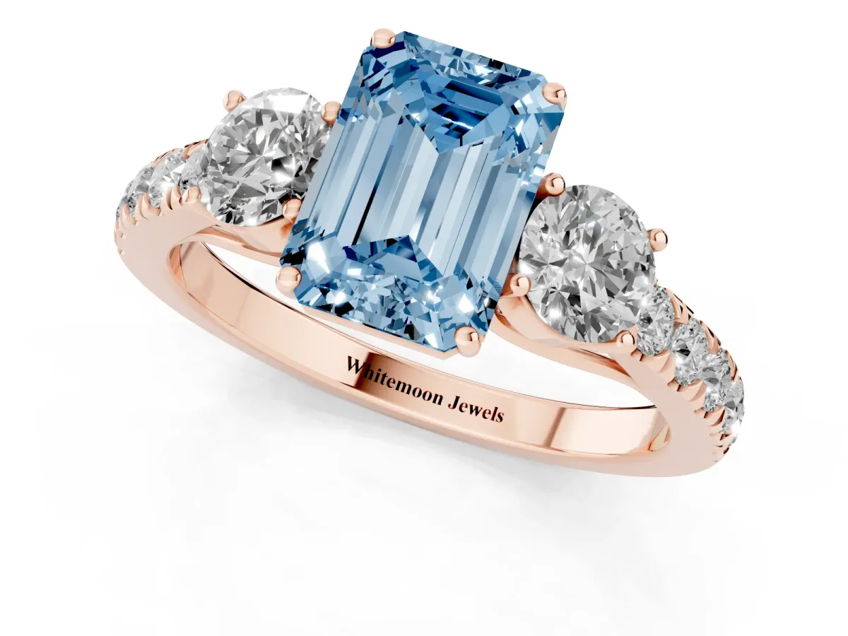 Fancy Blue Emerald Cut Cut Diamond Three-Stone Ring with Round Side Stones and Pavé Band Rose gold