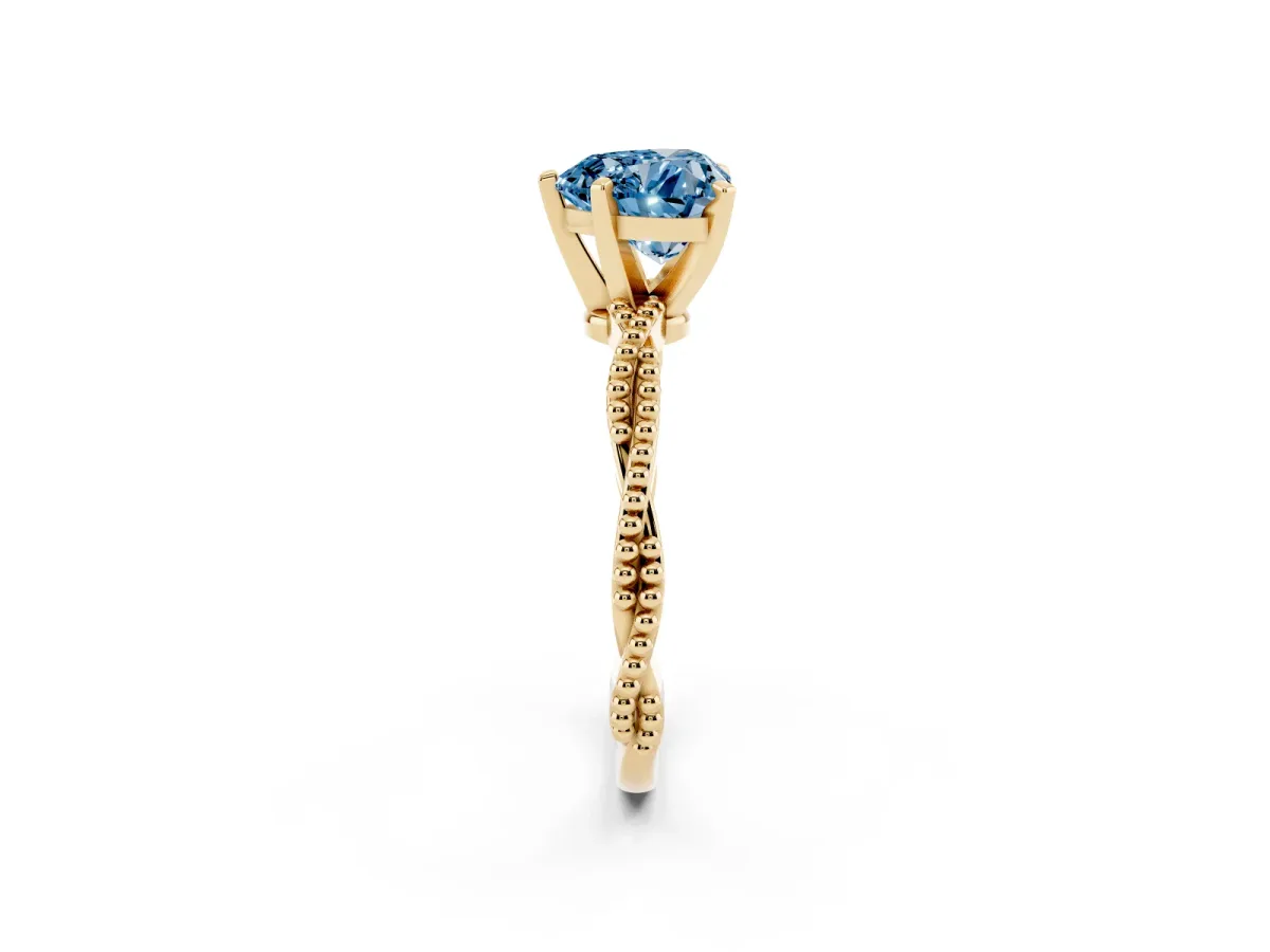 Fancy Blue Heart Cut Solitaire Twisted Band with Bead Prong Setting Yellow gold