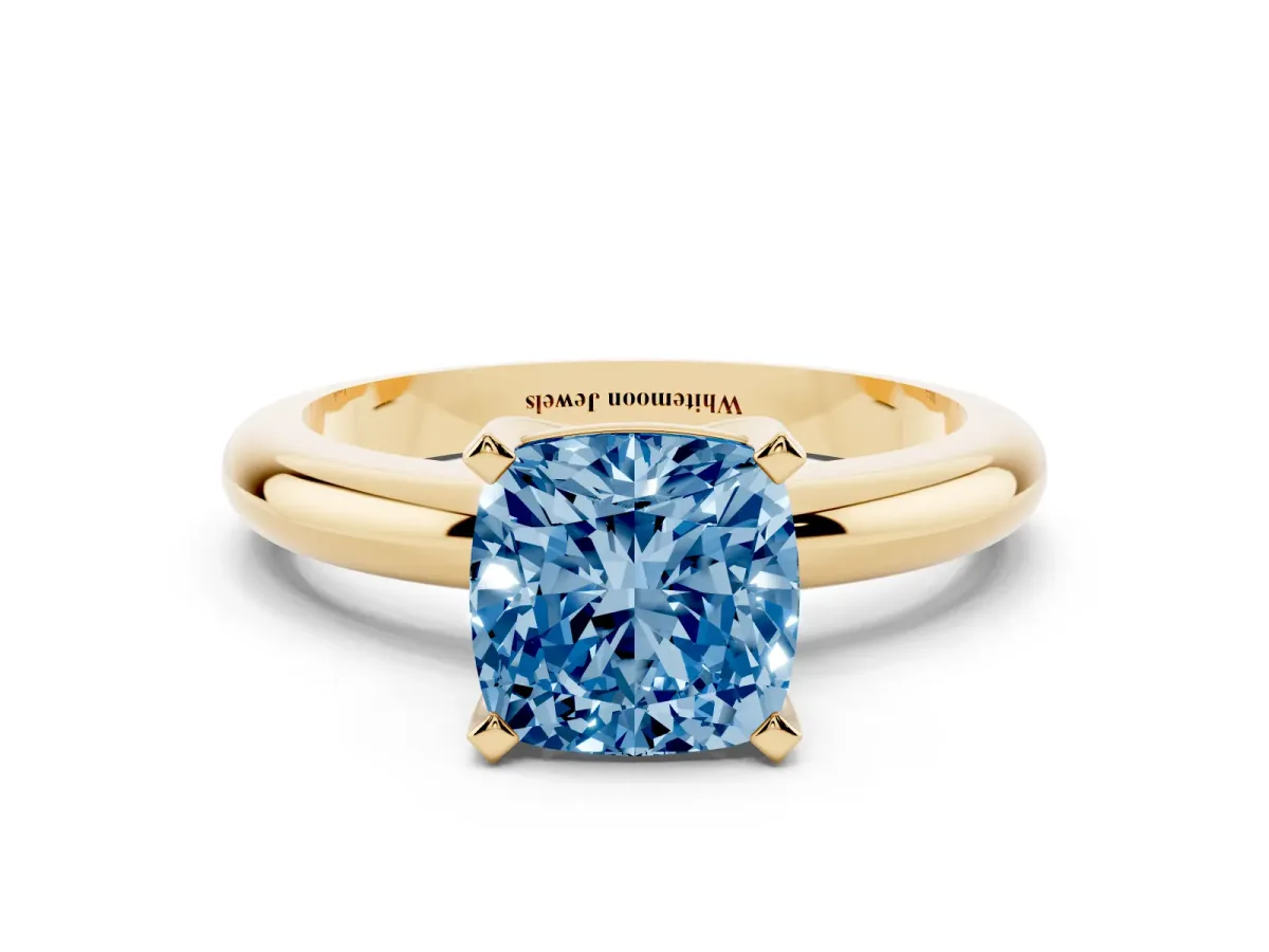 Fancy Blue Cushion Cut Diamond Solitaire Engagement Ring with Round Band and Four-Prong Setting Yellow gold