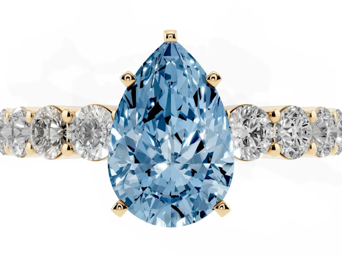Fancy Blue Pear Cut Diamond Solitaire Ring with Shared Prong Round Side Stones Yellow gold