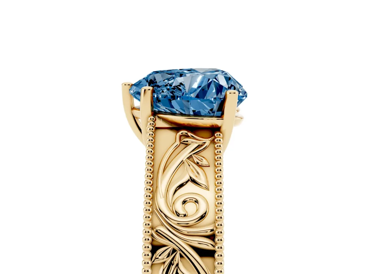 Fancy Blue Heart Cut Diamond Solitaire Ring with Engraved Band and Four-Prong Setting Yellow gold