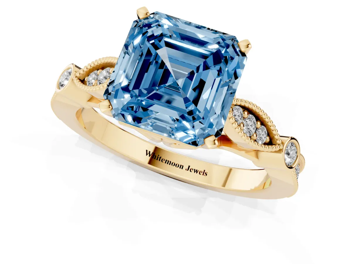Fancy Blue Asscher Cut Cut Diamond with Milgrain Marquise and Bezel Accents on a Solitaire Band with Prong Setting Yellow gold