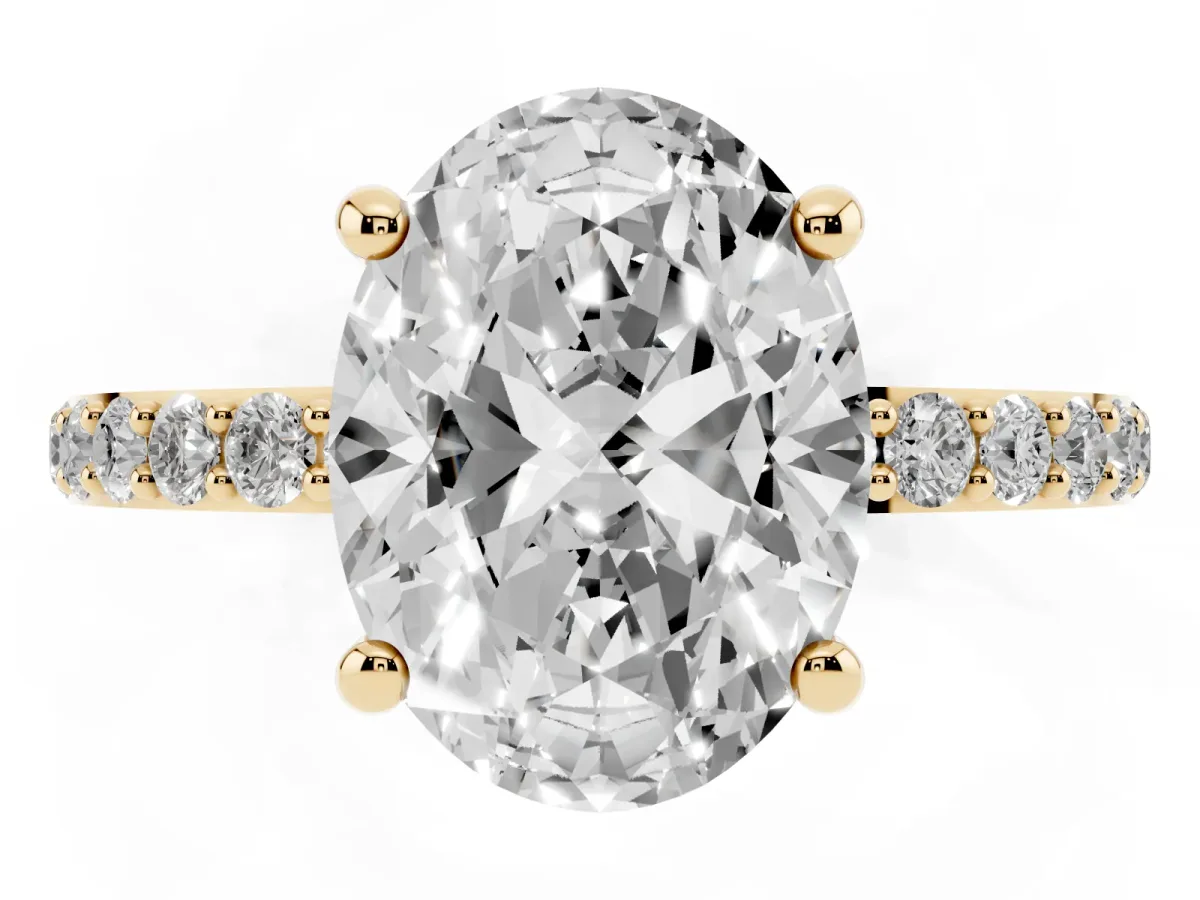 Oval Cut Diamond Solitaire Ring with Round Pavé Band and Prong Setting Yellow gold