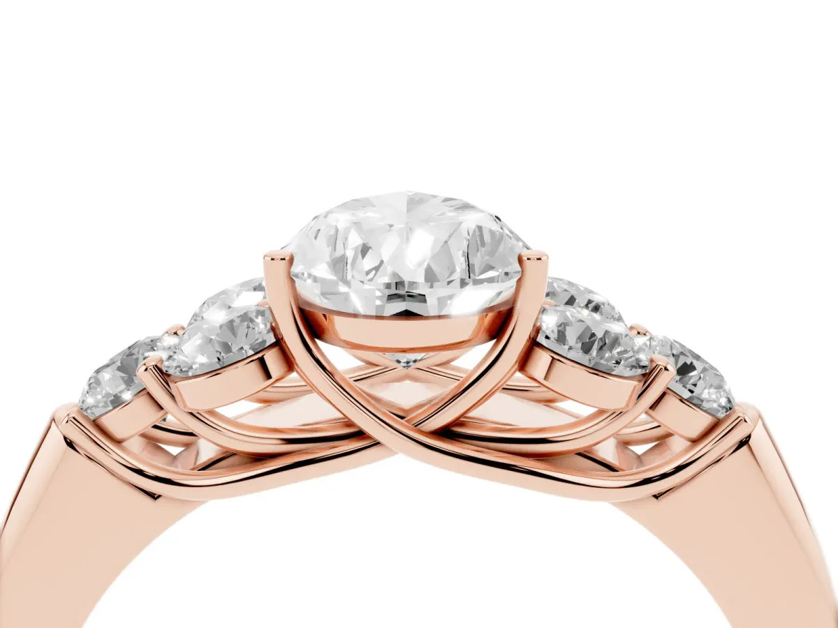 Pear Cut Cut Diamond Cluster Ring with Round Accent Stones and Prong Setting on a Classic Band Rose gold