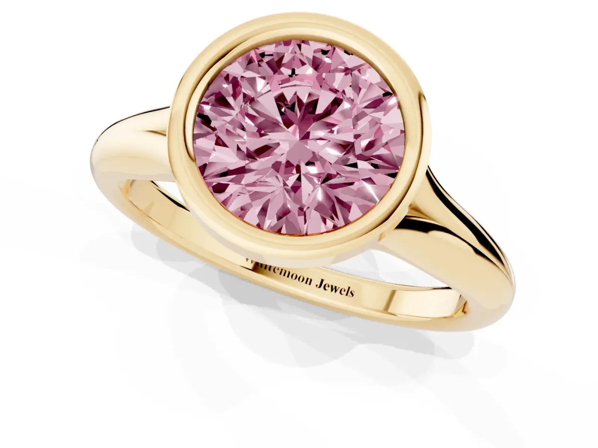 Fancy Pink Bezel Set Round Cut Solitaire Diamond Ring with Smooth Band Yellow gold