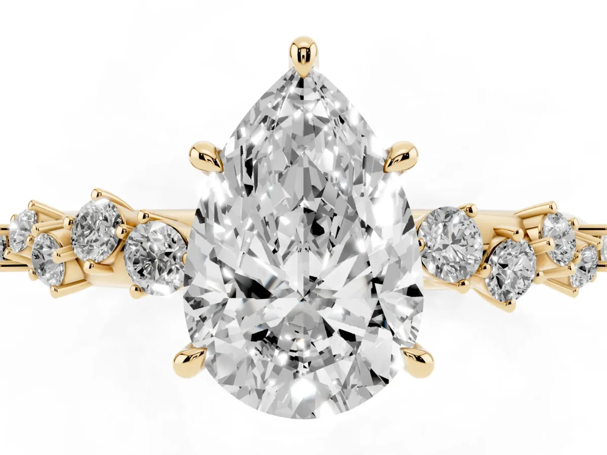 Pear Cut Diamond Cluster Side Stone Solitaire Ring with Prong Setting Yellow gold