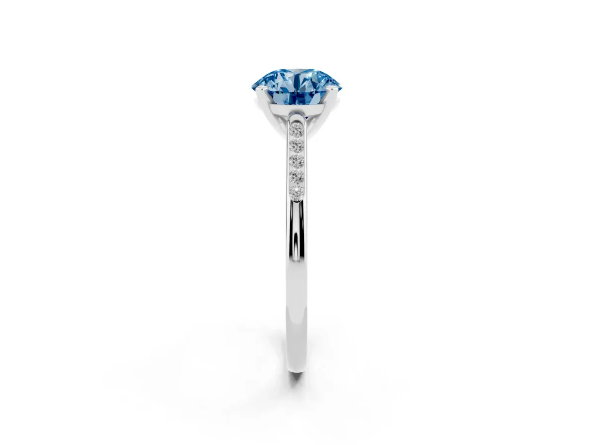 Fancy Blue Round Cut Diamond Solitaire Ring with Channel Set Round Band and Prong Setting Silver