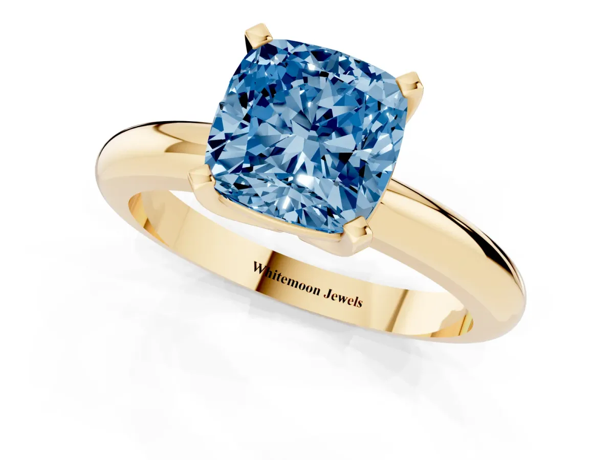 Fancy Blue Cushion Cut Diamond Solitaire Engagement Ring with Round Band and Four-Prong Setting Yellow gold
