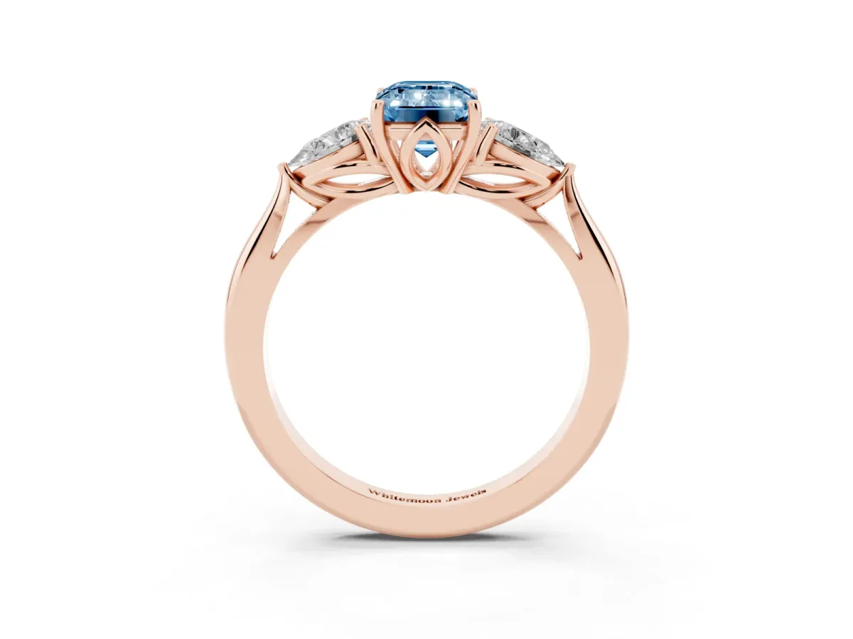 Fancy Blue Three-Stone Emerald Cut Brilliant Diamond Solitaire Ring with Tapered Band and Four-Prong Setting Rose gold