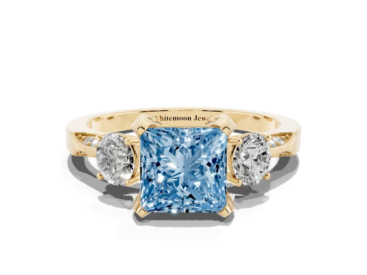 Fancy Blue Princess Cut Brilliant Three-Stone Diamond Ring with Pavé Band and Four-Prong Setting Yellow gold