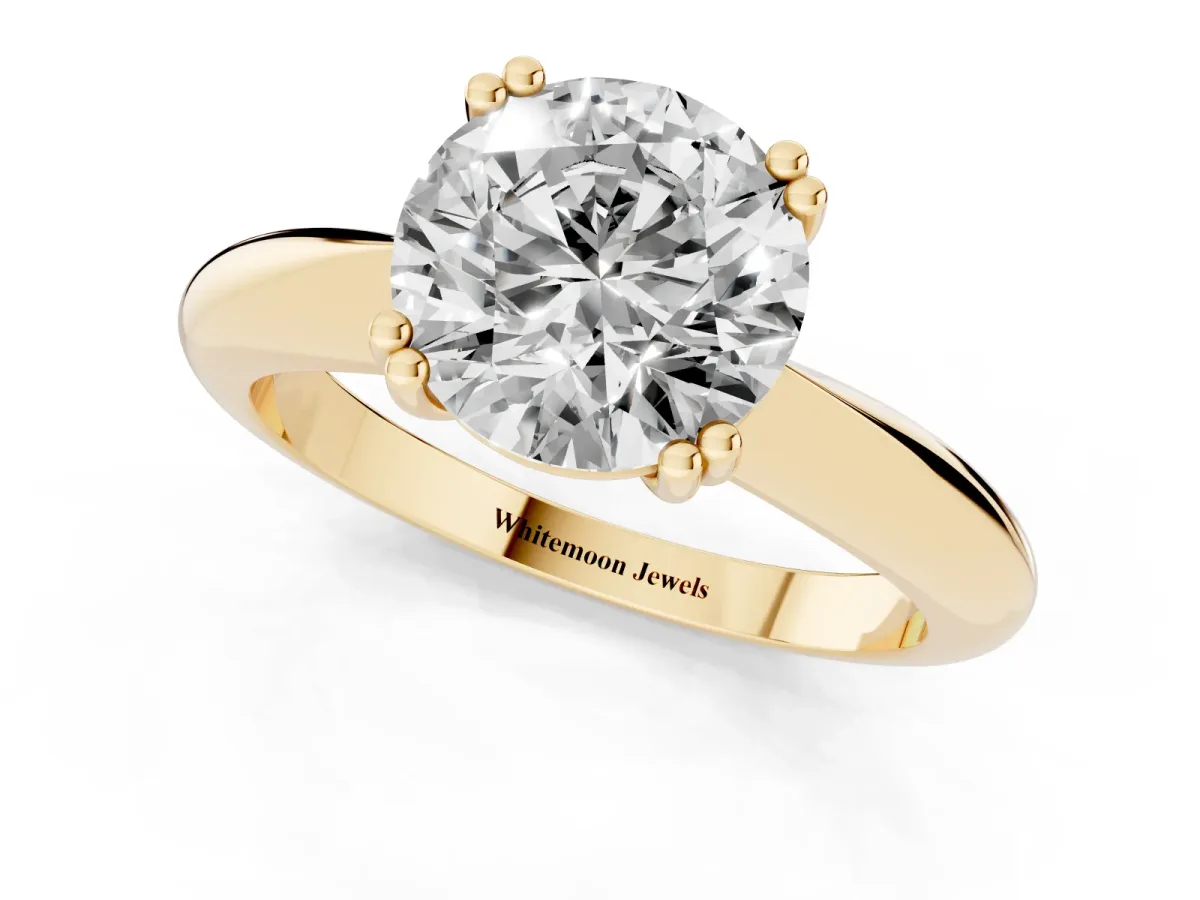 Round Cut Cut Solitaire Engagement Ring with Tapered Band and Four-Prong Setting Yellow gold