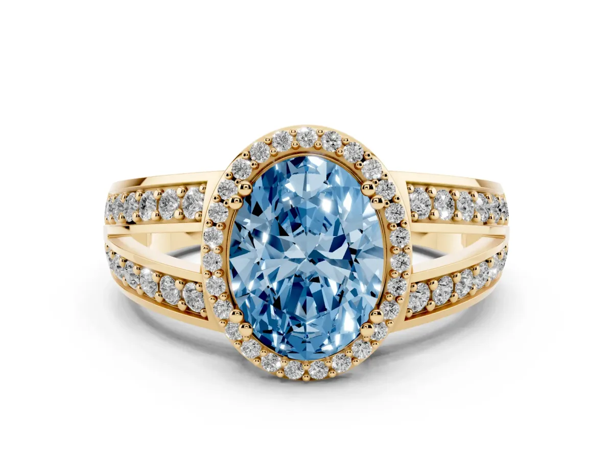 Fancy Blue Oval Cut Diamond Halo Ring with Split Shank Pavé Band and Four-Prong Setting Yellow gold