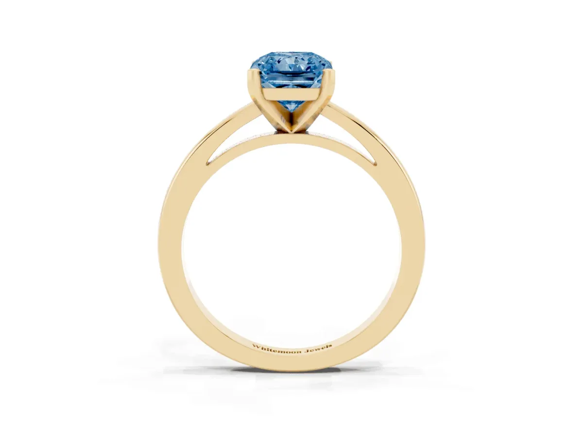 Fancy Blue Radiant Cut Solitaire Diamond Engagement Ring with Four-Prong Setting on a Classic Band Yellow gold