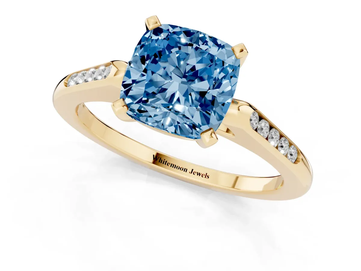 Fancy Blue Cushion Cut Diamond Solitaire Ring with Channel Set Round Band and Prong Setting Yellow gold