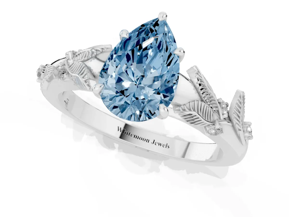 Fancy Blue Pear Cut Diamond Solitaire Ring with Leaf Motif Band and Four-Prong Setting Silver