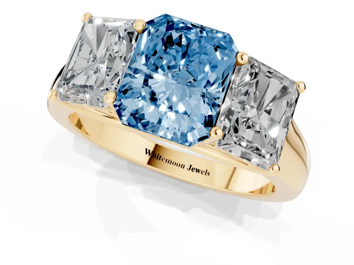 Fancy Blue Radiant Cut Three-Stone Diamond Ring with Prong Setting on a Classic Band Yellow gold